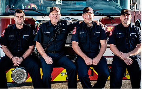Firefighters on Front of truck Cropped