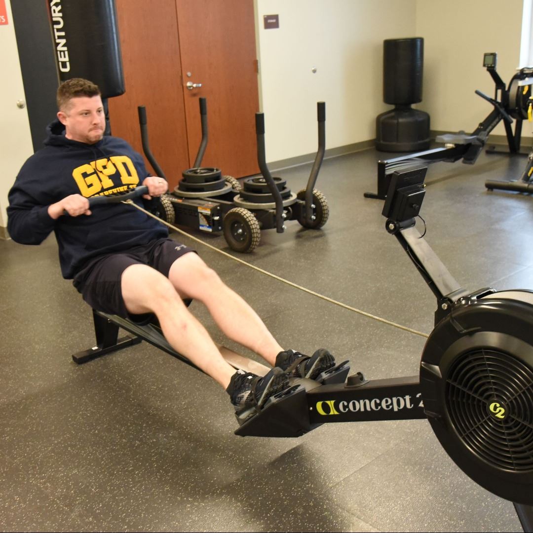 Man in gym using rowing machine