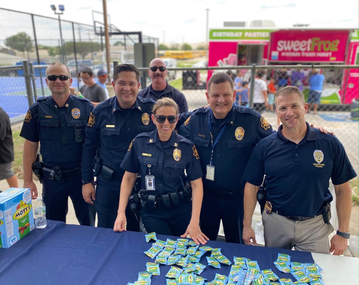officers standing at picnic table